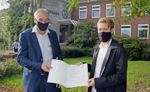 2 Männer halten eine Urkunde