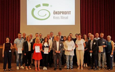 Gruppenbild, im Hintergrund Logo Ökoprofit projiziert